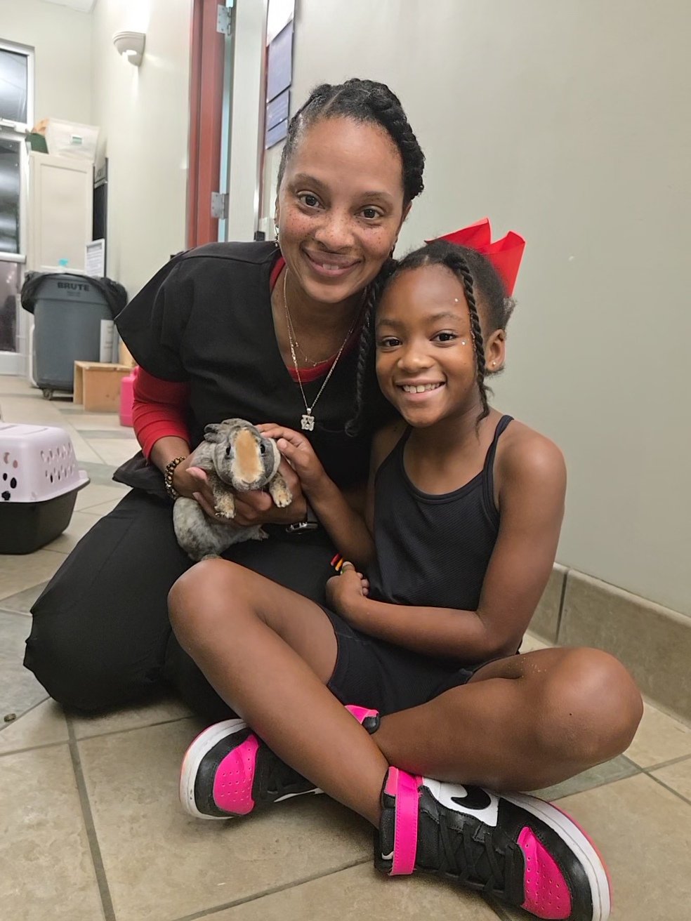 Mother and daughter smile with their new bunny adopted during the fee-waived Clear the Shelters event