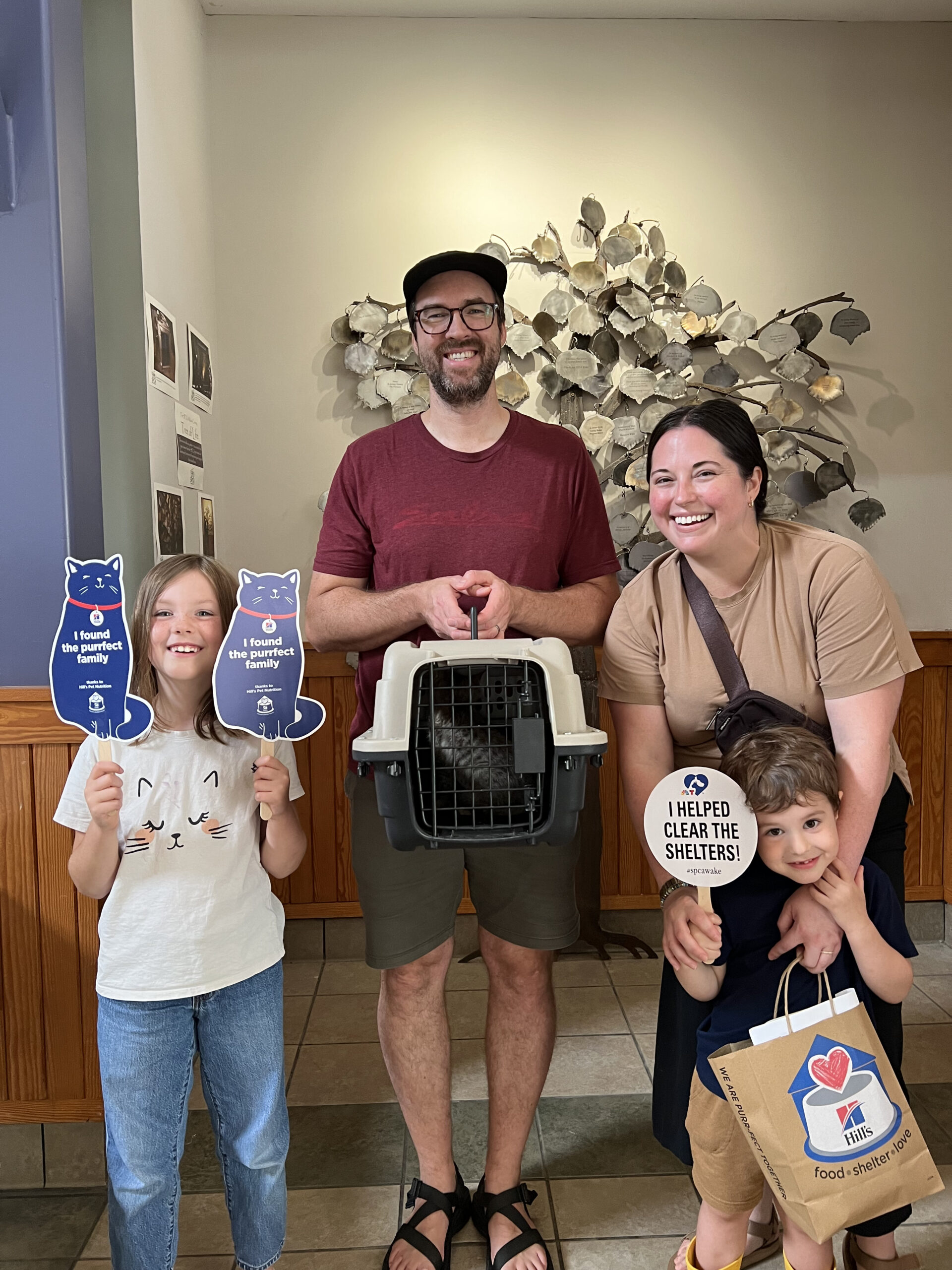 Family of four excited to bring home their new cat adopted during a fee-waived adoption promotion