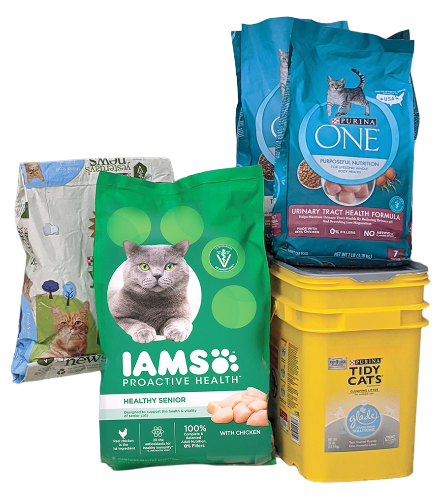 a pile of bags of cat food and cat litter stacked together